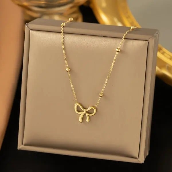 Colier choker auriu pentru femei din oțel chirurgical cu pandantiv integrat în formă de fundă 1