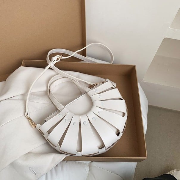 Damhandväska i fläktform med utskurna remsor Två korta handtag Lång justerbar axelrem Konstläder PU 27 x 17 x 10 cm vit