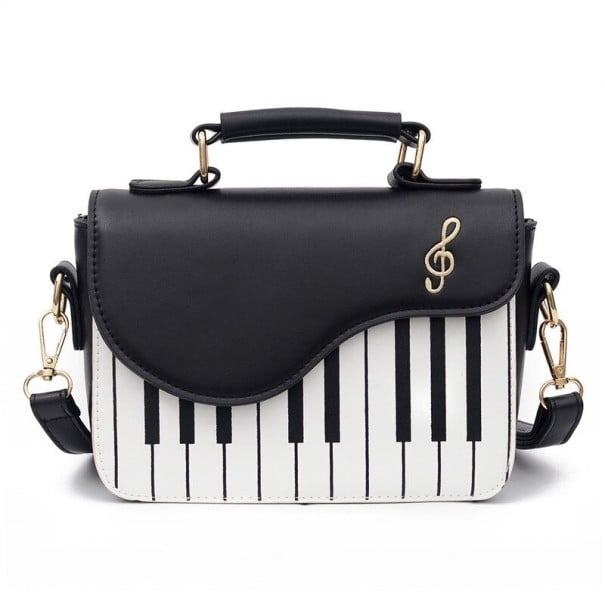 Damen Crossbody Tasche mit Motiv der Klaviertasten und Violinschlüssel Griff zum Halten in der Hand und Gurt über den Körper PU Leder schwarz