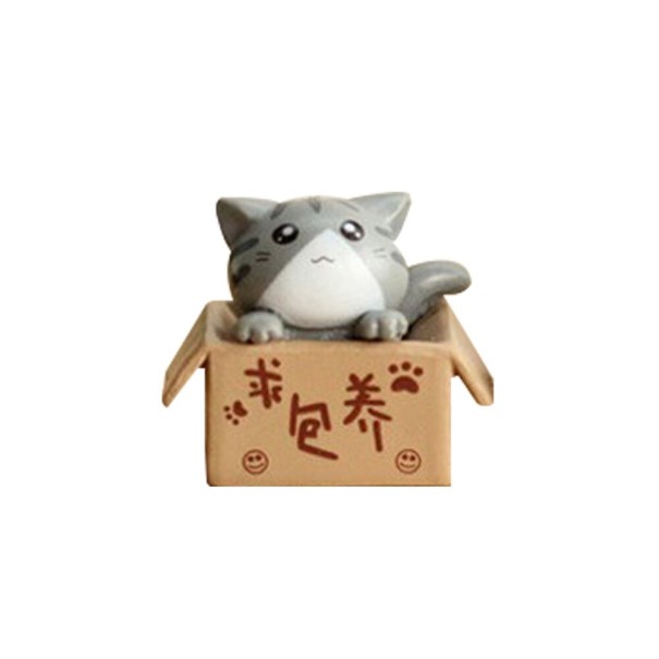 Gato en miniatura decorativo en una caja gris