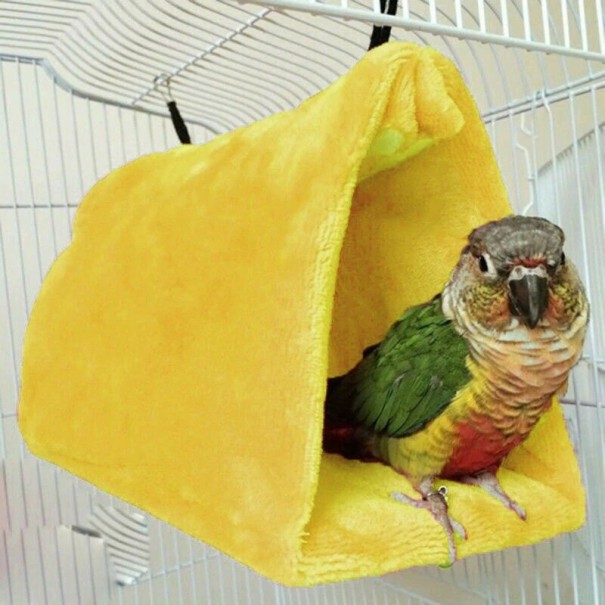 Hangend pluchen bed voor de kooi
