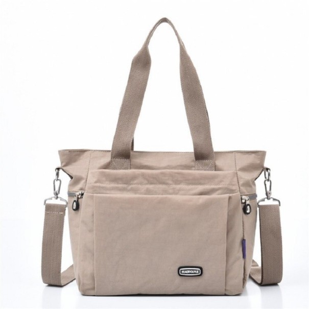 Ladies' shoulder bag made of polyester Two handles Detachable strap with carabiners Front zip pocket Dimensions 32 x 27 x 17 cm beige