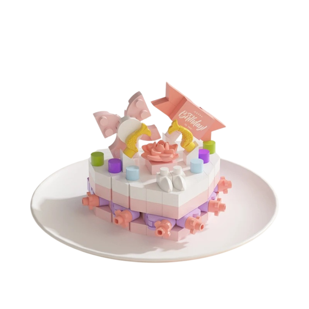 Mini kit de construction 5,5 x 3,5 x 4,5 cm de gâteau d'anniversaire dans des tons roses et blancs avec des rubans, une fleur rose et de petites 1