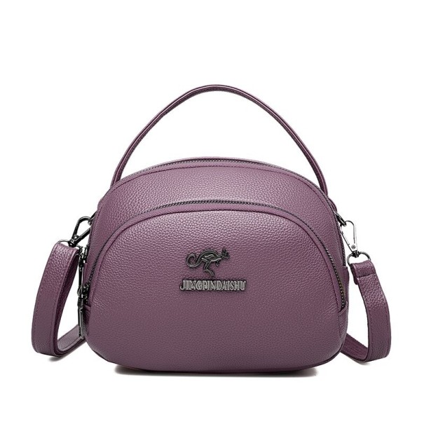 Női crossbody táska kerek formában, felső füllel és pánttal Több cipzáras rekesz Szemcsés PU bőr 21 x 17 x 10 cm Kézben és vállon lila