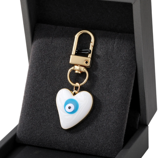 Péndulo para llaves 2,5 x 3 cm Aleación de zinc Ojo Maligno corazón Amuleto protector para llaves bolso mochila decoración blanco