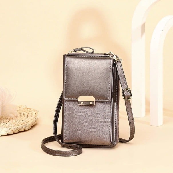 Small women's crossbody bag made of PU leather Front pocket with flap and metal buckle Zip at the top Thin strap with buckle 19 x 11 cm bronze