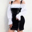 Dam svart mini klänning med axelband och kedjor Två dragkedjor fram Bälte med metallöglor Kontrastfärgad vit söm Polyester med bomull och spandex 1