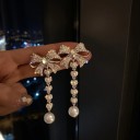 Boucles d'oreilles pendantes pour femmes en forme de nœud 1