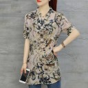 Damblus med blommönster och kort ärm Förlängd passform V-ringning Rundad nederkant Blandning av polyester, akryl och spandex 8