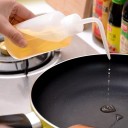 Aspersor curvo de 1000 ml, transparente, botella grande para riego y dosificación con control de flujo preciso. 4