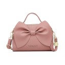 Bolso de mano para mujer con gran lazo, para llevar en la mano o al hombro. Ecocuero. Correa ajustable. Cierre de cremallera. 23 x 15 x 4