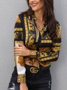 Camisa feminina com padrão de leopardo e ornamentos dourados Riscas pretas e painéis brancos Manga longa com punho Gola clássica Fecho de botões 3