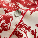 Damepyjamas i hvid med røde mønstre Skjorte med krave og lange ærmer med knapper og lomme på brystet samt bukser af polyester og rayon 3