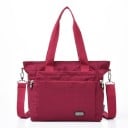 Dames schoudertas van polyester Twee handvatten Afneembare schouderband met karabijnhaken Voorvak met rits Afmetingen 32 x 27 x 17 cm 9
