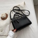Ladies' handbag for hand or shoulder carry made of artificial leather Round handles with a gold metal arch Front zip pocket 23.5 x 17 x 10 cm 1