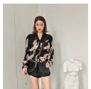 Ladies' shirt with a print of flying birds on a black background Long sleeves Notched collar Slightly looser fit Polyester with spandex 4