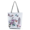 Naisten kangaskassi maailman nähtävyyksien ja kukkien kuvilla Ostoskassi harmailla kahvoilla Kangasta ja polyesteria 27 x 38 x 11 cm Kahvat 27 cm 3