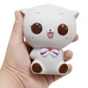 Stressiä lievittävä puristuskissa rentoutumiseen Istuva kissa, jossa on nauha ja suuret silmät Pehmeä polyuretaani Valkoinen vaaleanpunaisella 1