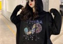 Sudadera negra oversize para mujer con capucha y estampado espacial con el texto Arizona. Bolsillo canguro. Cuerdas ajustables. Poliéster y algodón. 4