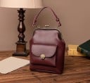 Women's crossbody handbag with a metal frame and ball clasp Handle and detachable strap Front pocket with a rotating lock 18 x 24 x 7 cm 3