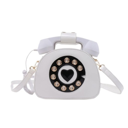Dams crossbody-väska i form av en retrotelefon Nummerskiva med hjärta och hörlurar med snodd PU-läder och polyester 21 x 16 x 9 cm