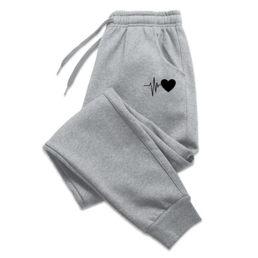 Bekvemme, løse joggingbukser til kvinder med hjerteprint. Afslappede bløde bukser til hjemmet og udendørs. Bekvemme sportsbukser med elastisk talje.