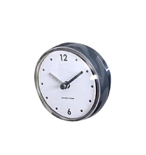 Kleine analoge Uhr mit rundem Kunststoffgehäuse und transparentem Deckel. Übersichtlich weißes Ziffernblatt. Abmessungen 7,2 x 4 cm