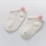 Șosete pentru bebeluși cu pompon alb